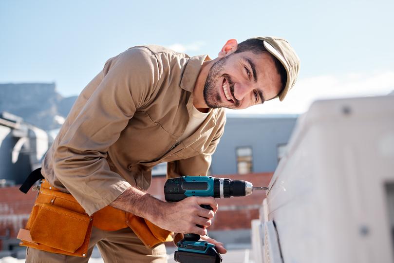 A roofer installing a new roof on a house